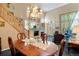 A chandelier hangs above a formal dining table in this stylish living area at 5155 W Quincy Ave # 101, Denver, CO 80236
