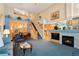 Open-concept living space with a fireplace, dining area, staircase, and lots of space at 5155 W Quincy Ave # 101, Denver, CO 80236