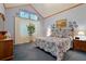 Serene main bedroom featuring high ceilings, soft colors, and comfortable furnishings at 5155 W Quincy Ave # 101, Denver, CO 80236