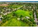 Aerial view of the neighborhood park with green space, mature trees, and play areas at 5155 W Quincy Ave # 101, Denver, CO 80236