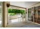 Charming covered patio with white furniture and view to lush greenery at 5155 W Quincy Ave # 101, Denver, CO 80236