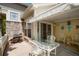 Inviting outdoor patio with comfortable seating, awning, and stone accents at 5155 W Quincy Ave # 101, Denver, CO 80236