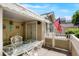 Relaxing patio with decorative seating, awning, and view of American flag at 5155 W Quincy Ave # 101, Denver, CO 80236