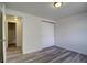 Bedroom features wood-look floors, closet, and attached bathroom at 7396 S Knolls Way, Centennial, CO 80122