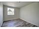 Bright bedroom featuring wood-look floors and a window with natural light at 7396 S Knolls Way, Centennial, CO 80122