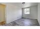 Bedroom with wood-look floors and a window for natural light at 7396 S Knolls Way, Centennial, CO 80122
