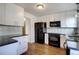 Updated kitchen with white cabinets, modern appliances, and a stylish backsplash design at 7396 S Knolls Way, Centennial, CO 80122