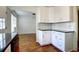 Well-designed kitchen with white cabinetry, black countertops, and an adjacent dining area at 7396 S Knolls Way, Centennial, CO 80122