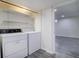Functional laundry room with shelving and gray flooring at 7396 S Knolls Way, Centennial, CO 80122