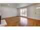 Spacious living area with wood floors, a fireplace, and a large window offering great views at 7396 S Knolls Way, Centennial, CO 80122