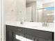 Bathroom featuring a double sink vanity, wood look floors, a glass-enclosed shower and neutral color palette at 6068 Corral St, Brighton, CO 80601