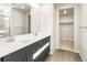 Beautiful bathroom showcasing double sinks with a walk-in closet featuring abundant storage space at 6068 Corral St, Brighton, CO 80601