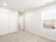 Bright bedroom featuring a large window, closet, and neutral carpeting at 6068 Corral St, Brighton, CO 80601