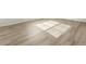 A living room with wood-look floors is brightly lit by sun coming through the blinds at 6068 Corral St, Brighton, CO 80601