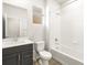 Clean bathroom with gray vanity, white tiles, and a shower-tub combination at 6068 Corral St, Brighton, CO 80601