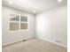Cozy bedroom with carpet flooring, a window, and fresh white paint at 6068 Corral St, Brighton, CO 80601