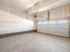 Spacious two-car garage with concrete floors and a white garage door at 6068 Corral St, Brighton, CO 80601