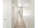 Bright hallway with light hardwood floors leading to rooms in the house at 6068 Corral St, Brighton, CO 80601