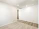 Open living area with combined carpet and wood flooring and neutral paint at 6068 Corral St, Brighton, CO 80601