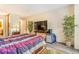 Spacious bedroom featuring stylish bedding, a large TV, and plenty of natural light, perfect for relaxation at 12655 E Pacific Cir # E, Aurora, CO 80014