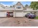 Townhome featuring attached garages, light gray siding and a well-maintained driveway on a sunny day at 12655 E Pacific Cir # E, Aurora, CO 80014