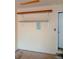 Garage interior featuring mounted shelves and electrical panel on a light yellow wall at 12655 E Pacific Cir # E, Aurora, CO 80014
