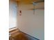 Garage interior featuring mounted shelves, a fire extinguisher and a door on the left side at 12655 E Pacific Cir # E, Aurora, CO 80014