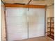 Picture of a white garage door with metal hinges and an automatic door opening mechanism at 12655 E Pacific Cir # E, Aurora, CO 80014