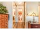Hallway with mirrored closet doors, wood floors, dresser, and lamp at 12655 E Pacific Cir # E, Aurora, CO 80014
