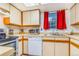 Bright kitchen with white cabinets, stainless steel appliances, and a window at 12655 E Pacific Cir # E, Aurora, CO 80014