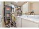 Efficient laundry area featuring modern appliances, water heater, and ample storage space at 12655 E Pacific Cir # E, Aurora, CO 80014