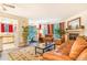 Bright living room featuring a fireplace, comfortable furniture, and a turquoise front door at 12655 E Pacific Cir # E, Aurora, CO 80014