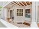 Cozy covered porch with seating, a doormat, and a glass sliding door at 12655 E Pacific Cir # E, Aurora, CO 80014