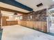 Finished basement with exposed brick wall, wooden trim and light brown carpet at 1076 S Leyden St, Denver, CO 80224
