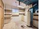Utility room with storage shelves, laundry machines, and hot water heater at 1076 S Leyden St, Denver, CO 80224