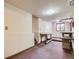 Unfinished basement space with exposed pipes and simple wooden work benches at 1076 S Leyden St, Denver, CO 80224