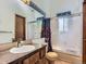 Bathroom with decorative mirror, single sink vanity and shower with sliding door at 1076 S Leyden St, Denver, CO 80224
