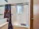 Bathroom shower with sliding door and decorative curtain at 1076 S Leyden St, Denver, CO 80224