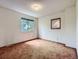 Bedroom with light brown carpet, neutral walls, and one window at 1076 S Leyden St, Denver, CO 80224