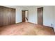 Bedroom with light brown carpet, neutral walls and wood trim, and closet at 1076 S Leyden St, Denver, CO 80224