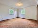 Bedroom with two windows, neutral walls, and light brown carpet at 1076 S Leyden St, Denver, CO 80224