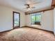 Bedroom with light brown carpet, neutral walls, ceiling fan, and access to a balcony at 1076 S Leyden St, Denver, CO 80224