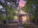 Charming home with a red door, exposed beams, and lush trees at 1076 S Leyden St, Denver, CO 80224