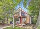 Charming home with a red door, exposed beams, and lush landscaping at 1076 S Leyden St, Denver, CO 80224