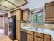 Kitchen with stainless steel sink and wooden cabinets at 1076 S Leyden St, Denver, CO 80224