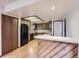 Traditional kitchen featuring wooden cabinets, laminate countertops and backsplash, and modern appliances at 1076 S Leyden St, Denver, CO 80224