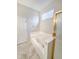 Bright bathroom showcases a large soaking tub beneath a window, with a glass shower door and tile flooring at 9806 Hooker Ct, Denver, CO 80031