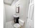 Bathroom featuring a toilet, vanity, and a mirror at 9806 Hooker Ct, Denver, CO 80031