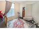 Bedroom with a large window, closet, exercise bike and colorful rug at 9806 Hooker Ct, Denver, CO 80031