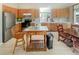 Charming kitchen with stainless steel appliances, wood cabinets, and a central island at 9806 Hooker Ct, Denver, CO 80031